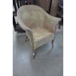 A Lloyd Loom Lusty gold wicker armchair