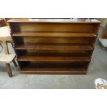 A mahogany waterfall front open bookcase