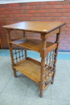 An Arts and Crafts Leonard Wyburd oak bookstand, retailed by Liberty & Co.