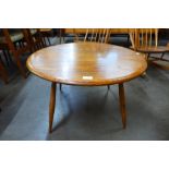 An Ercol elm and beech circular coffee table