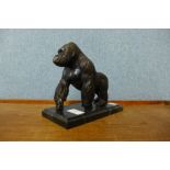 A bronze figure of a gorilla, on black marble socle