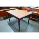 A teak extending dining table