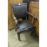A George IV elm and leather elbow chair