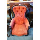 A Victorian carved mahogany and fabric upholstered spoonback armchair