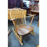 An Ercol Blonde elm and beech Windsor rocking chair