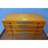 A vintage beech six drawer printers cabinet, containing printers type