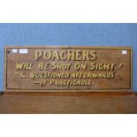 A painted wooden Poachers Will Be Shot On Sight sign