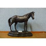 A bronze figure of a horse, on black marble socle