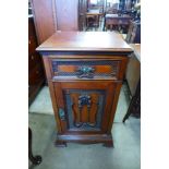 A Victorian carved mahogany pot cupboard