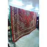 A large red ground rug, 364 x 273cms