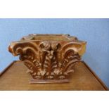 A carved wood Corinthian capital planter