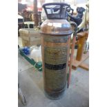 A vintage copper fire extinguisher