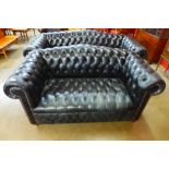 A black leather Chesterfield settee
