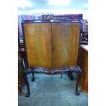 A Queen Anne style mahogany two door cabinet on stand