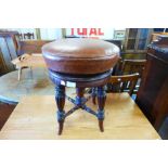 A Victorian mahogany and leather revolving piano stool