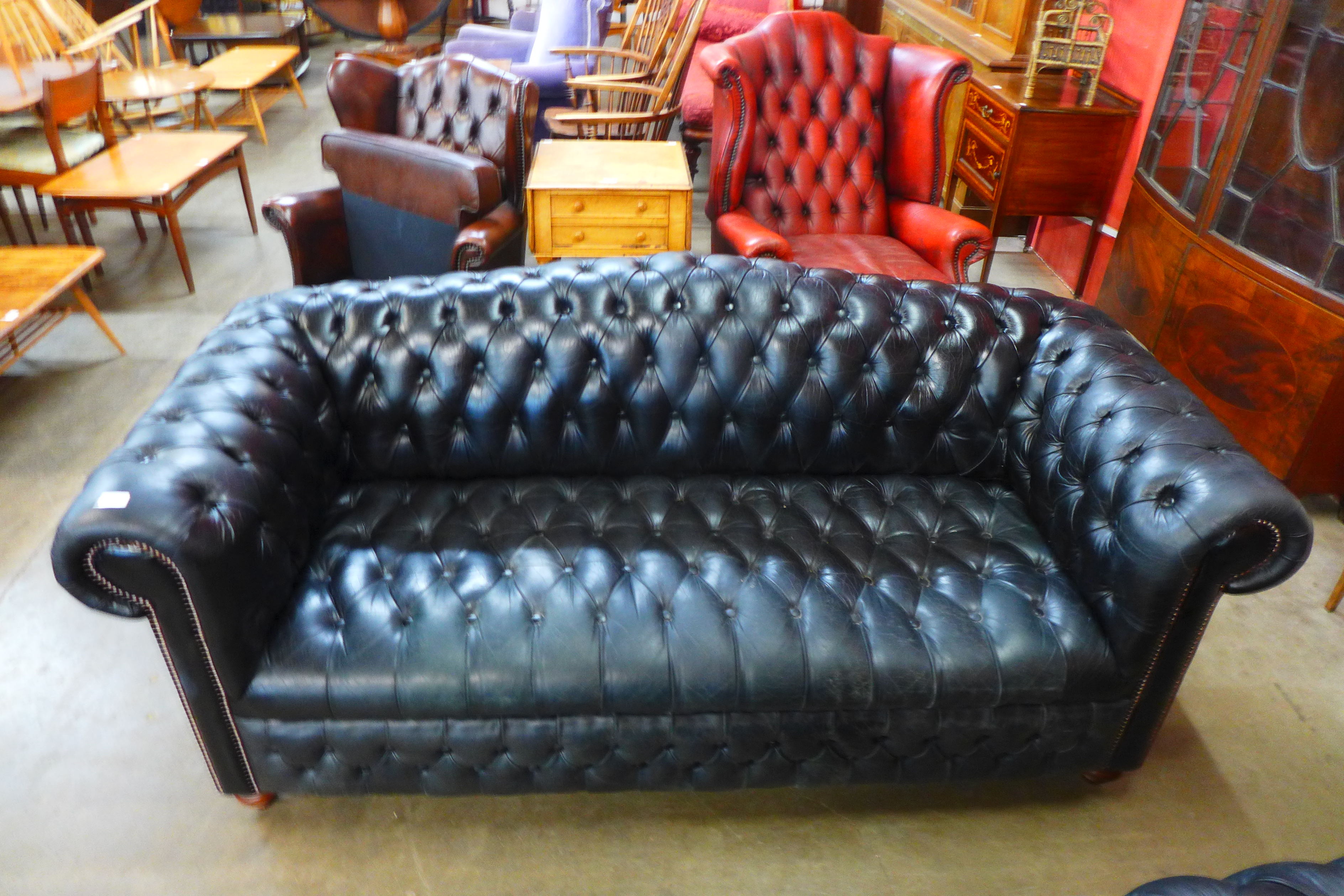 A black leather Chesterfield settee