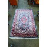 An Eastern hand knotted pink ground rug, 195 x 125cms