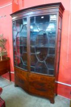 An Edward VII inlaid mahogany astragal glazed two door bow front bookcase