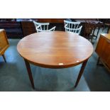 A teak extending dining table