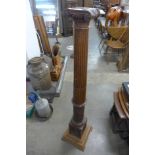 A late 18th Century carved oak Ionic column torchere