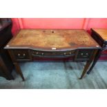 An Edward VII mahogany and leather topped bow centre writing table