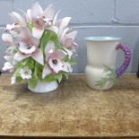 A Capodimonte centrepiece and a Clarice Cliff jug, small chip on the spout