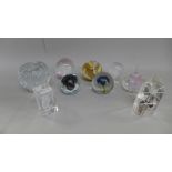 Nine glass paperweights including three laser