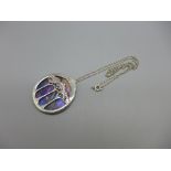 A silver and coloured glass Art Nouveau style pendant and chain, 39mm wide