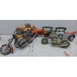 A box of cast iron door stops in the form of vintage motor cars and two models of motorbikes **