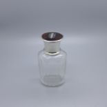 A glass bottle with silver and tortoiseshell top, with inner stopper, 9cm