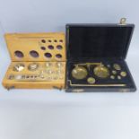 A cased brass set of gold weighing scales with a boxed set of weights