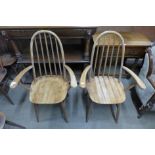 A pair of Ercol style light oak elbow chairs