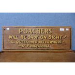 A painted wooden Poachers Will Be Shot On Sight sign