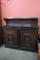 A Victorian carved oak two door bookcase