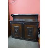 A Victorian carved oak two door bookcase