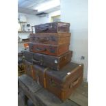 An early 20th Century steamer trunk and four suitcases