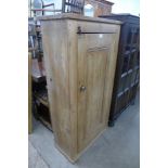 A pine single door kitchen cupboard