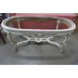 A French cream, parcel gilt and onyx topped oval coffee table (marble a/f)