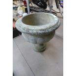 A concrete campana garden urn