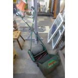 A vintage green metal Webb lawnmower