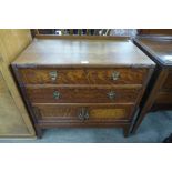 An early 20th Century carved oak chest of drawers