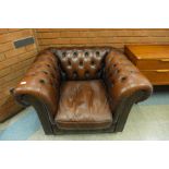 A brown leather Chesterfield club chair