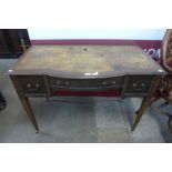 An Edward VII mahogany and leather topped bow centre writing table