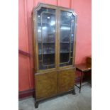 A George I style figured walnut four door bookcase