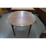 A teak extending dining table