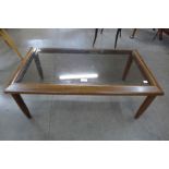 A teak and glass topped rectangular coffee table