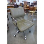 A chrome and grey vinyl revolving desk chair