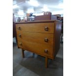 A teak chest of drawers