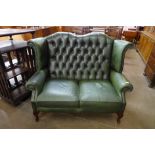 A green leather Chesterfield wingback settee