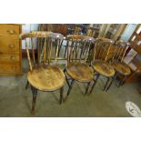 A set of four Victorian elm and beech penny seat kitchen chairs